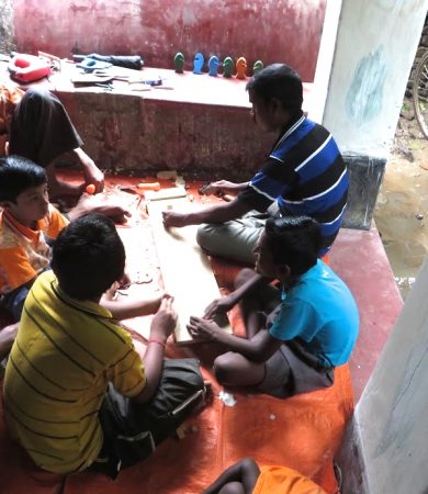 Volunteers teaching students of the carpentry program.